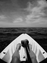 Low section of woman traveling in boat sailing on sea