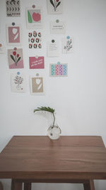 Potted plant on table against wall