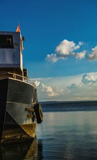 Ship moored on sea against sky