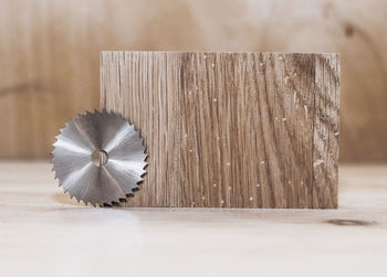 Circular saw on a wood background. workshop. manufacture of wooden products. joiner's cutting tool