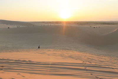 Scenic view of dessert against sky during sunset