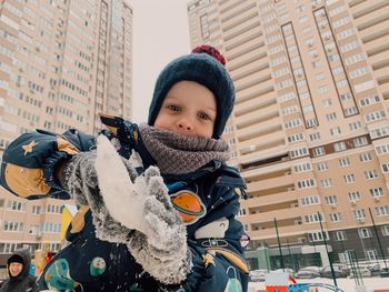 Portrait of a smiling boy on the street in winter