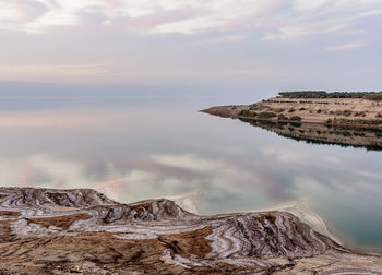 Rock formations by sea against sky