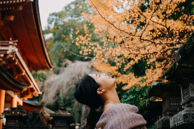 Portrait of woman standing at temple