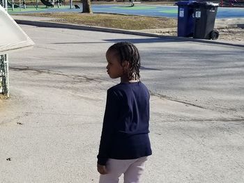 Full length of boy standing on landscape