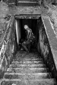High angle view portrait of man on staircase at tunnel
