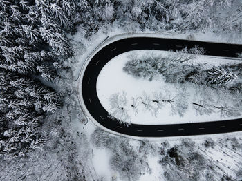 High angle view of snow covered field and road