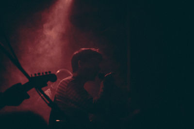 Man playing guitar at music concert