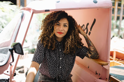 Portrait of young woman sitting in jinrikisha