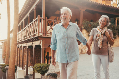 Portrait of smiling couple standing in city