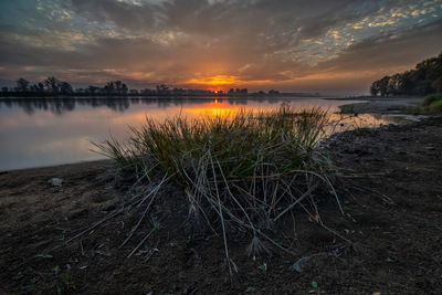 Scenic view of lake against sky during sunset