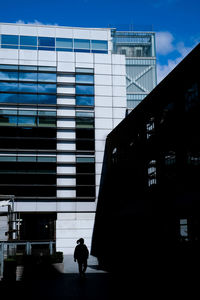 Small person silhouette against  tall buildings
