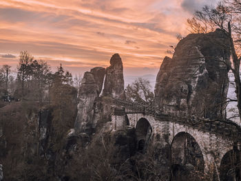 Arch bridge against sky during sunset