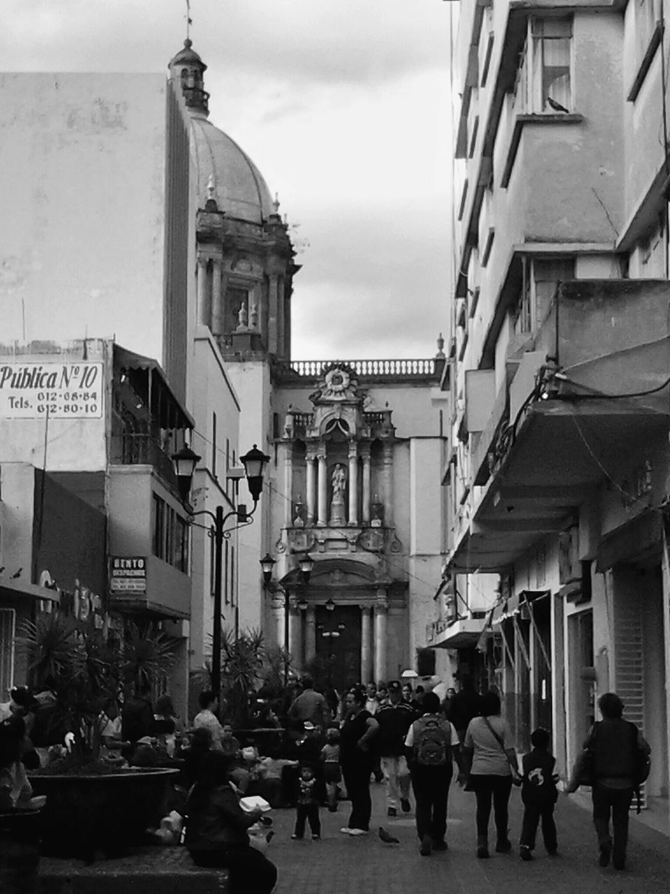 architecture, building exterior, built structure, large group of people, person, men, city, walking, street, city life, sky, lifestyles, cloud - sky, building, mixed age range, leisure activity, group of people, day, cloud