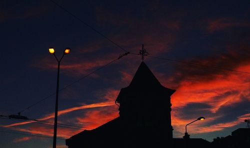 Low angle view of silhouette built structure against sky at dusk