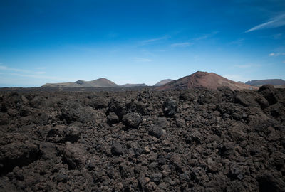 View of volcanic landscape against blue sky