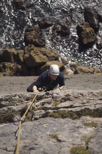 Man climbing rock on rocks