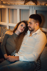 Young couple sitting in corridor