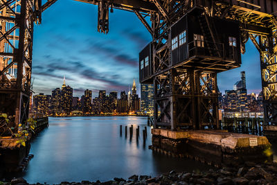 High angle view of river and cityscape against sky at dusk