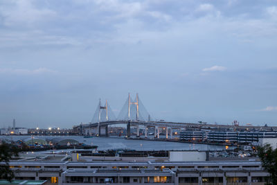 View of harbor bridge against cloudy sky
