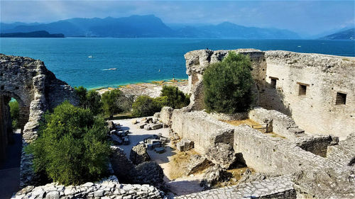 High angle view of historic building by sea against sky