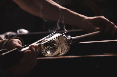 Cropped image of worker molding glass in workshop