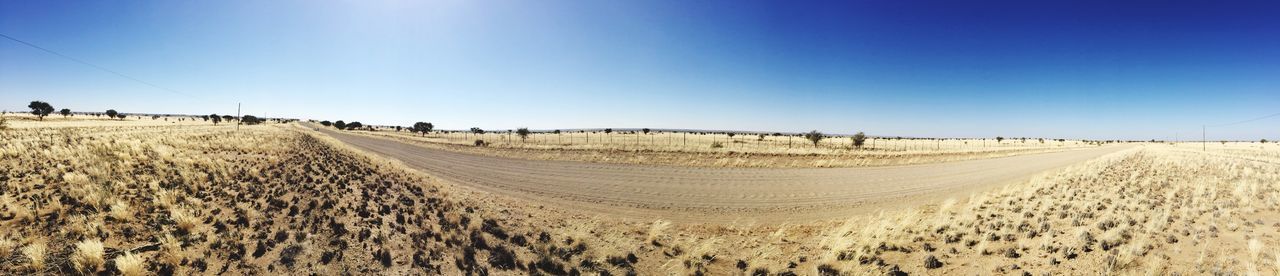 agriculture, tire track, nature, landscape, field, scenics, rural scene, clear sky, tranquility, tranquil scene, blue, day, beauty in nature, plough, panoramic, outdoors, sky, road, no people, plowed field