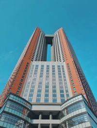 Low angle view of skyscraper against clear blue sky