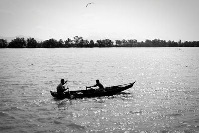 Men in boat on lake