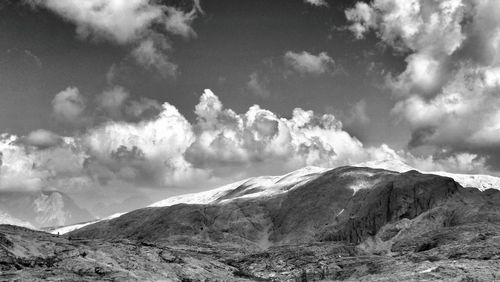 Scenic view of mountains against cloudy sky