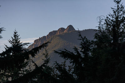 Low angle view of rocky mountains against clear sky