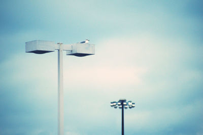 Low angle view of floodlight against sky