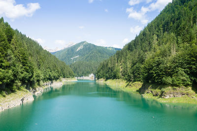 Scenic view of lake and mountains against sky