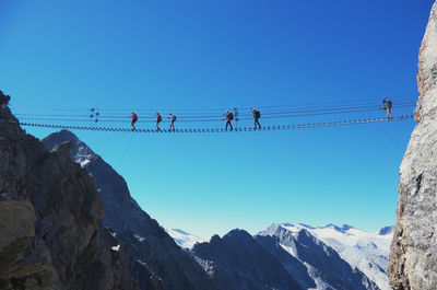 Low angle view of mountains against clear blue sky