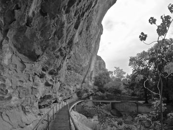 Low angle view of cave against sky