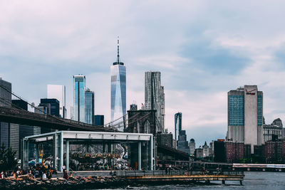 Modern buildings in city against cloudy sky