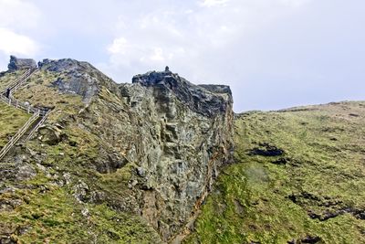 Low angle view of rocks on land against sky