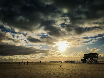 Scenic view of beach against sky during sunset