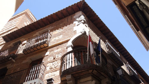 Low angle view of old building against clear blue sky