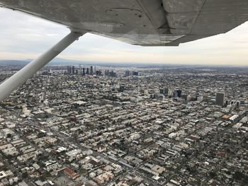 Aerial view of city and buildings against sky