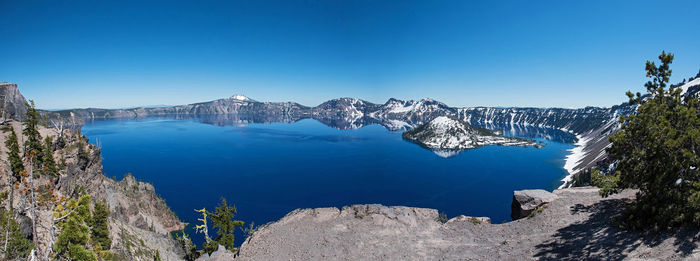 Scenic view of mountains against clear blue sky