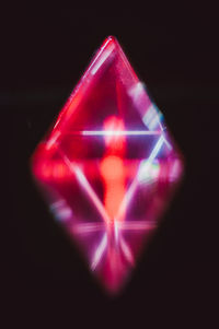 Close-up of illuminated lighting equipment against black background