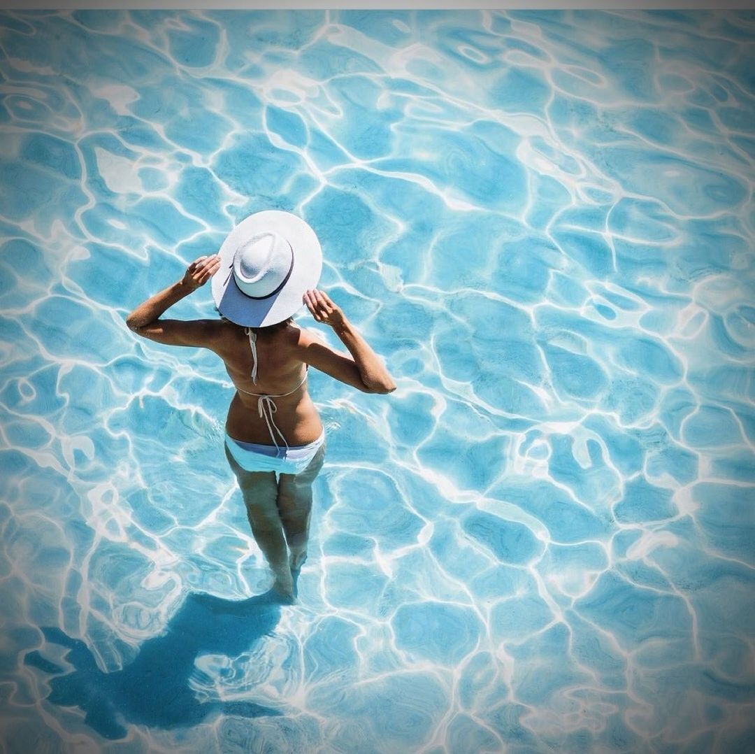 one person, water, swimming pool, clothing, adult, blue, swimming, women, nature, underwater, full length, high angle view, swimwear, hat, relaxation, leisure activity, reflection, lifestyles, vacation, day, trip, holiday, young adult, summer, person, sunlight, sun hat, female, outdoors, rippled, bikini, rear view, sea
