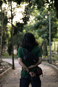 Rear view of man and woman walking on footpath