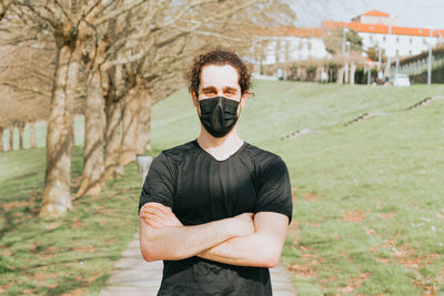 Portrait of young man wearing mask standing outdoors