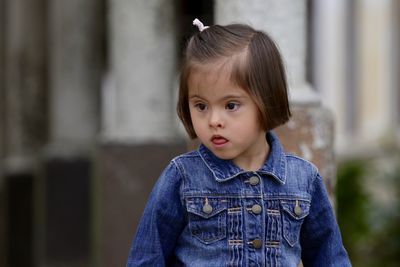 Portrait of young girl standing outdoors