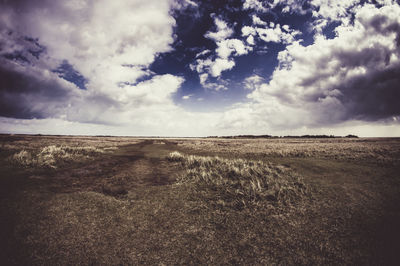 Scenic view of sea against cloudy sky