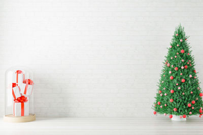 Christmas decoration on table against wall