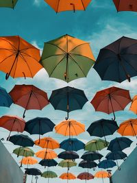 Low angle view of umbrellas against sky