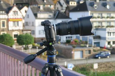 Close-up of camera with bicycle in city